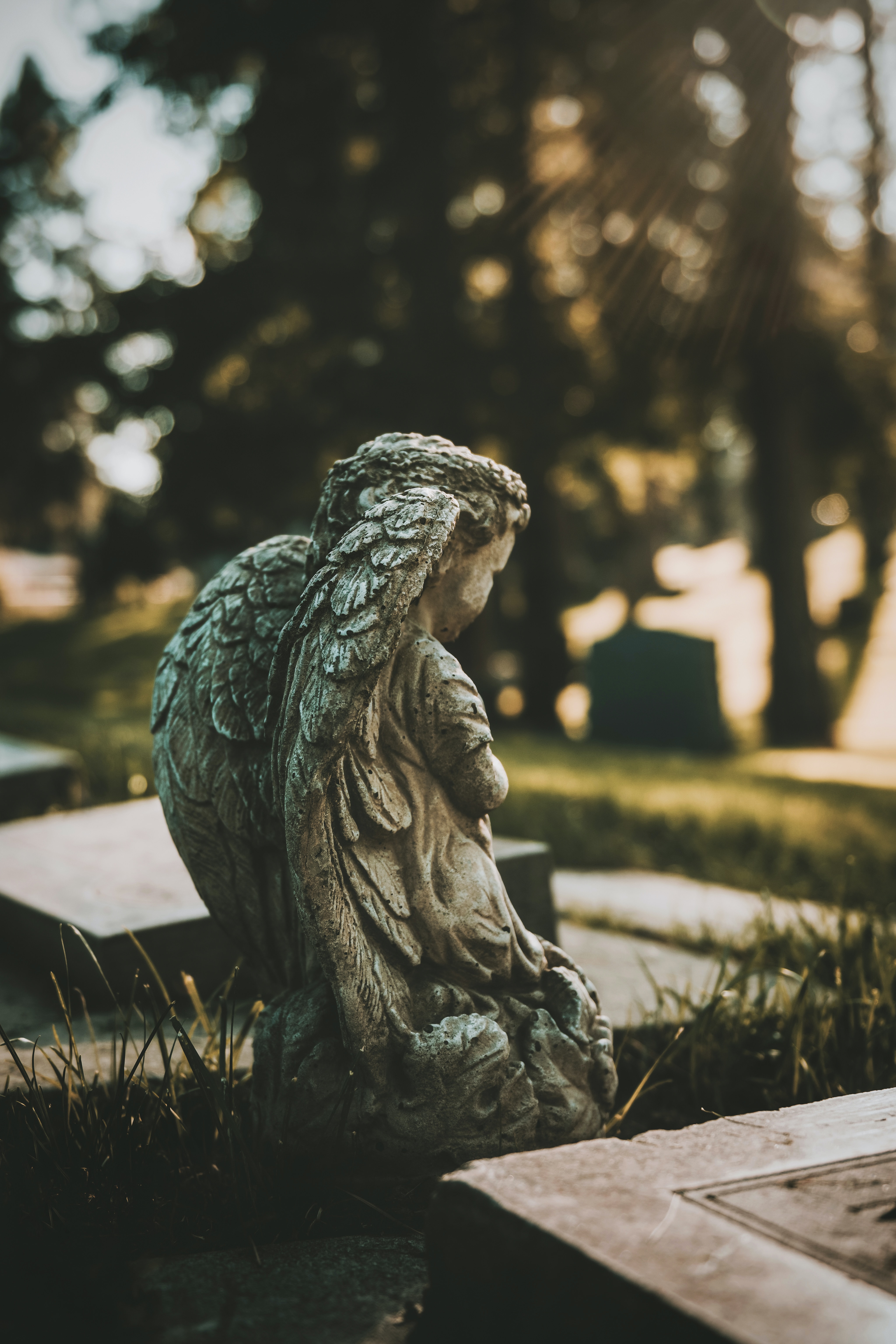 Small statue of an angel with its face looking away from the camera. This imagery represents how to navigate grief.