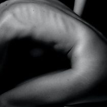A black and white photo of a person's side, showing defined ribs and muscles in dramatic lighting—perfect for showcasing the results of The Shifter Training Session’s injury prevention benefits.