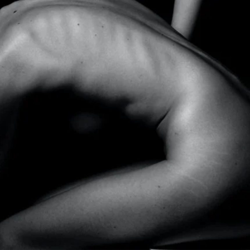 A black and white photo of a person's side, showing defined ribs and muscles in dramatic lighting—perfect for showcasing the results of The Shifter Training Session’s injury prevention benefits.