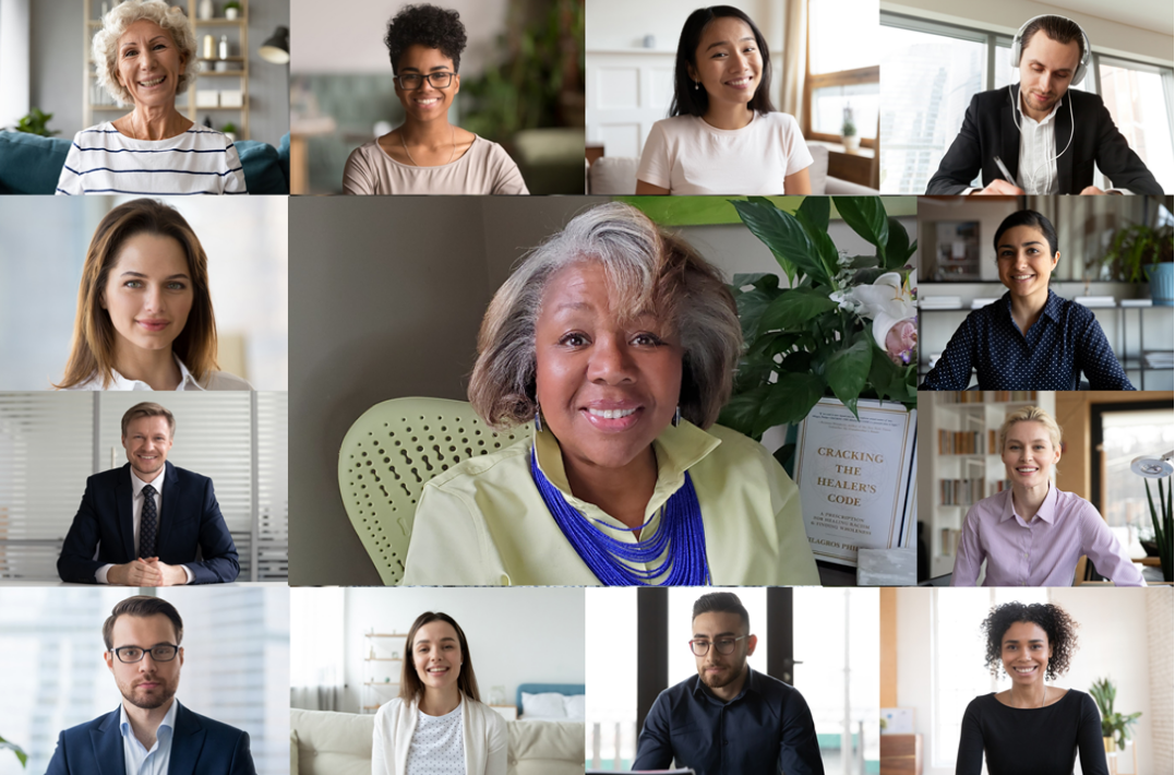 Fifteen diverse participants smile during a Race Literacy Lunch & Learn video call, each in their own frame. At the center, an older woman with gray hair and a blue necklace sits before a book and leafy plant.
