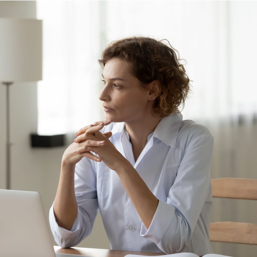 Woman reflecting before a difficult conversation during an online coaching session