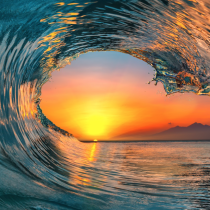 A vibrant ocean wave frames a colorful sunset and calm waters, with distant mountains silhouetted on the horizon—an inspiring scene reflecting the peace and insight youll find in Intuitive Clarity Mentorship.