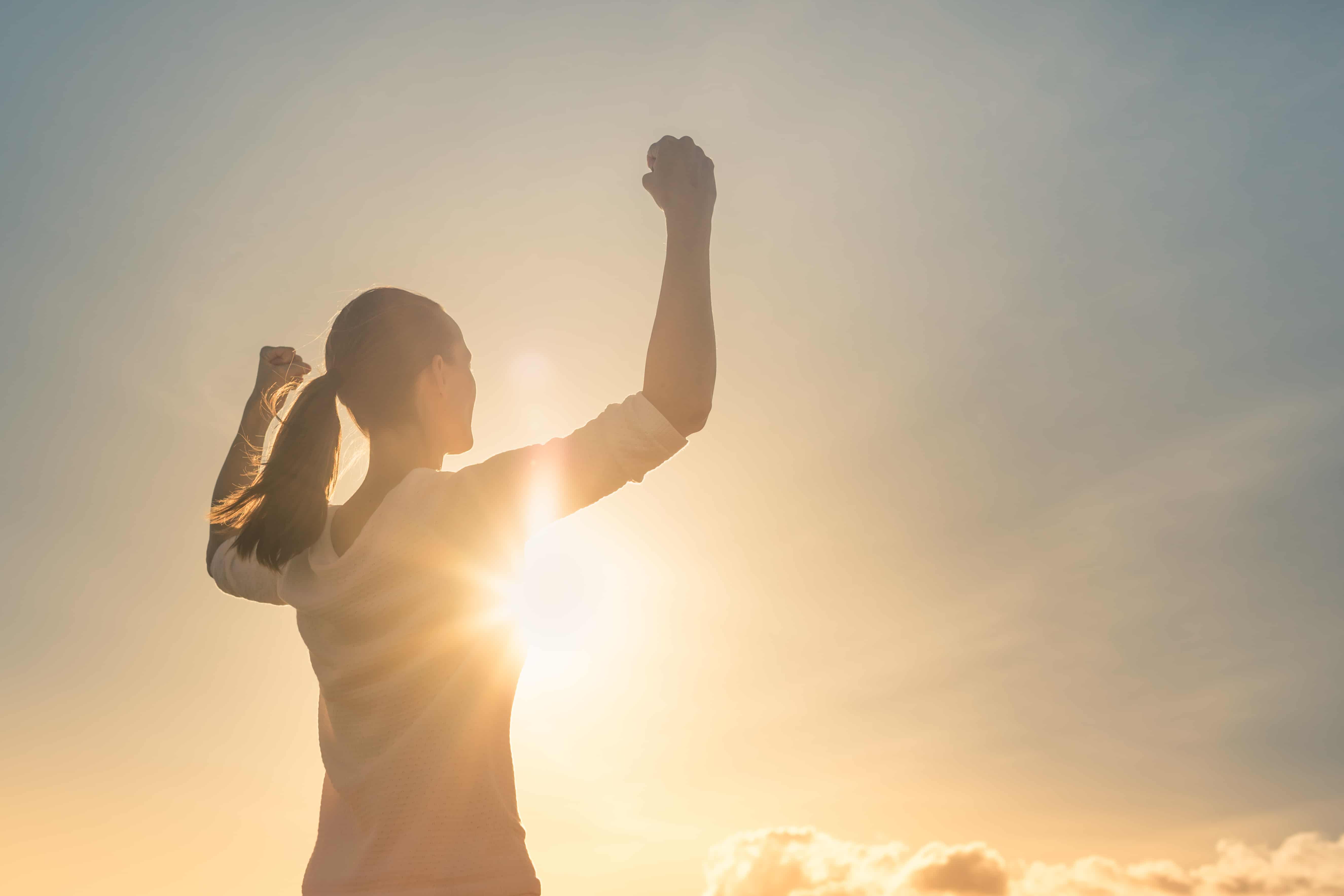 Find Your Strengths - Woman with arms in the air