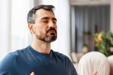 Person participating in an online meditation class at home.