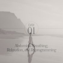 A person walks alone on a misty beach with cliffs. Overlay text reads: Day 01 Abdominal Breathing—Relaxation and breathwork for stress reprogramming. From Breathwork Week: Embody Clarity and Calm​.