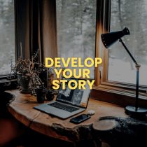 The Develop Your Story product is shown: a laptop, camera, phone, and lamp on a wooden desk by a window with snowy trees. Bold yellow text over the image states, “Develop Your Story.”.