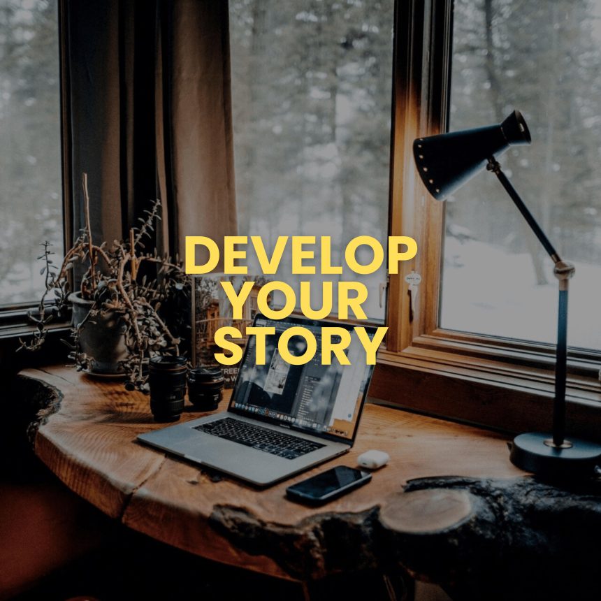 The Develop Your Story product is shown: a laptop, camera, phone, and lamp on a wooden desk by a window with snowy trees. Bold yellow text over the image states, “Develop Your Story.”.
