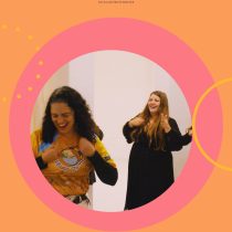 Two women smile and laugh inside a large pink and orange circular frame. At the top, Laughter As An Ally highlights laughter for resilience and joy in this stress relief team workshop setting.