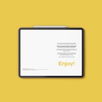The Happiness Journal tablet with a white screen and stylus pen rests on a solid yellow background. The display shows text, featuring the word Enjoy! in large yellow letters in the lower right corner.