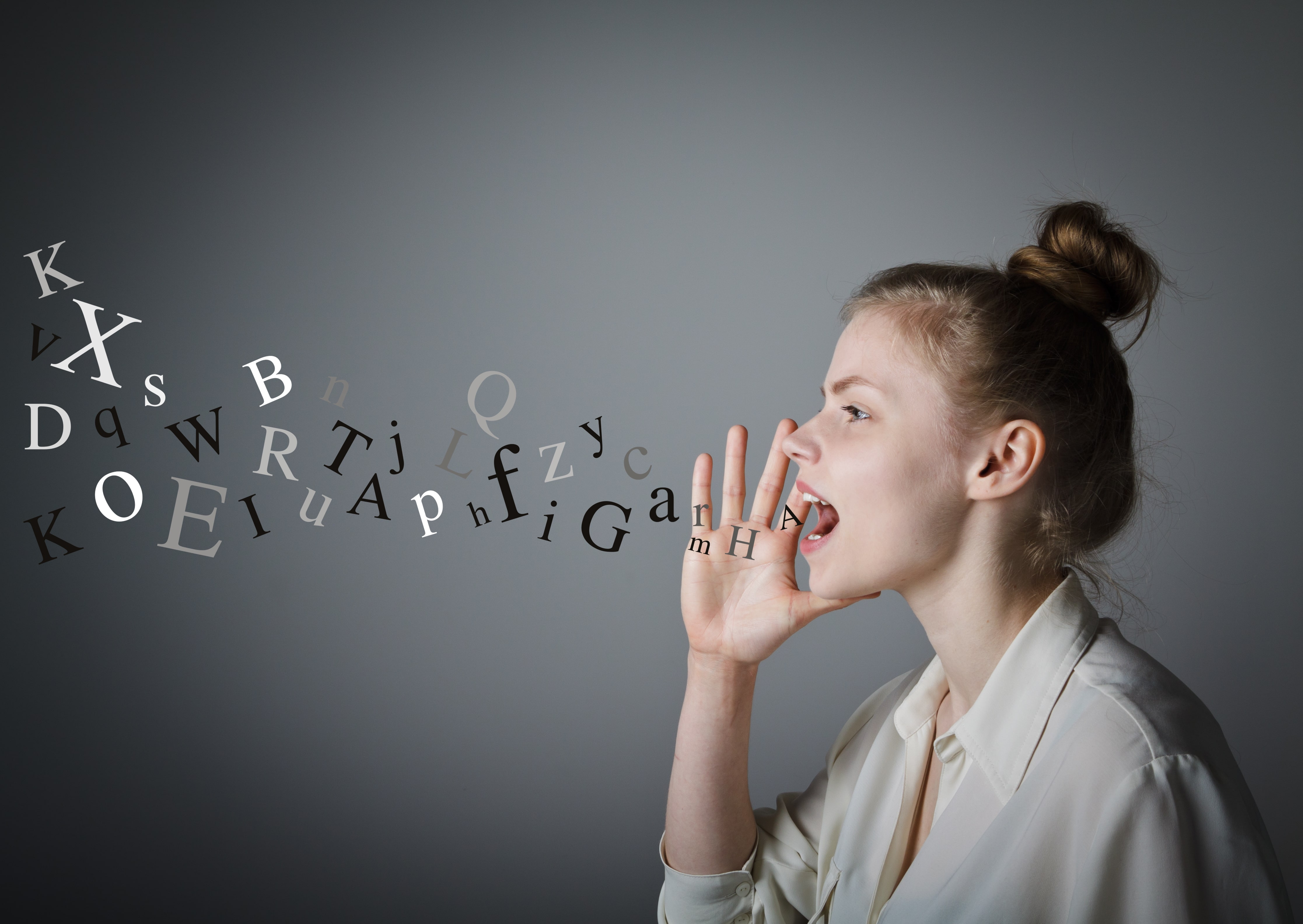 woman yelling with letters coming out of her mouth