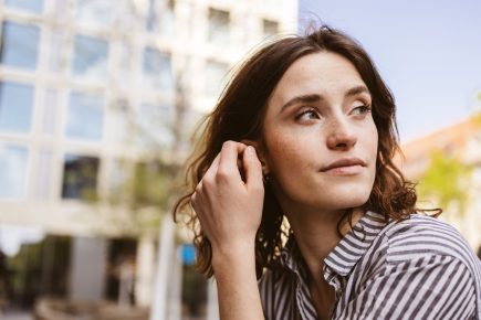 Thoughtful woman displaying the emotional sensitivity associated with empath traits