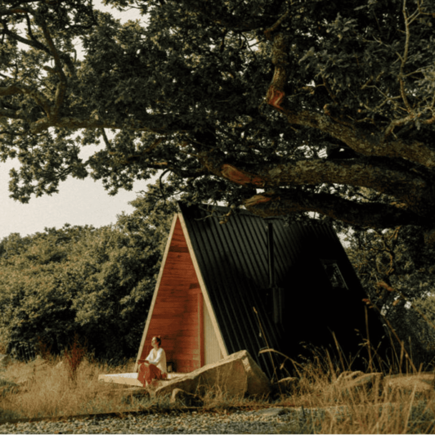 Guest relaxing outside an A-frame cabin at Cabilla Cornwall