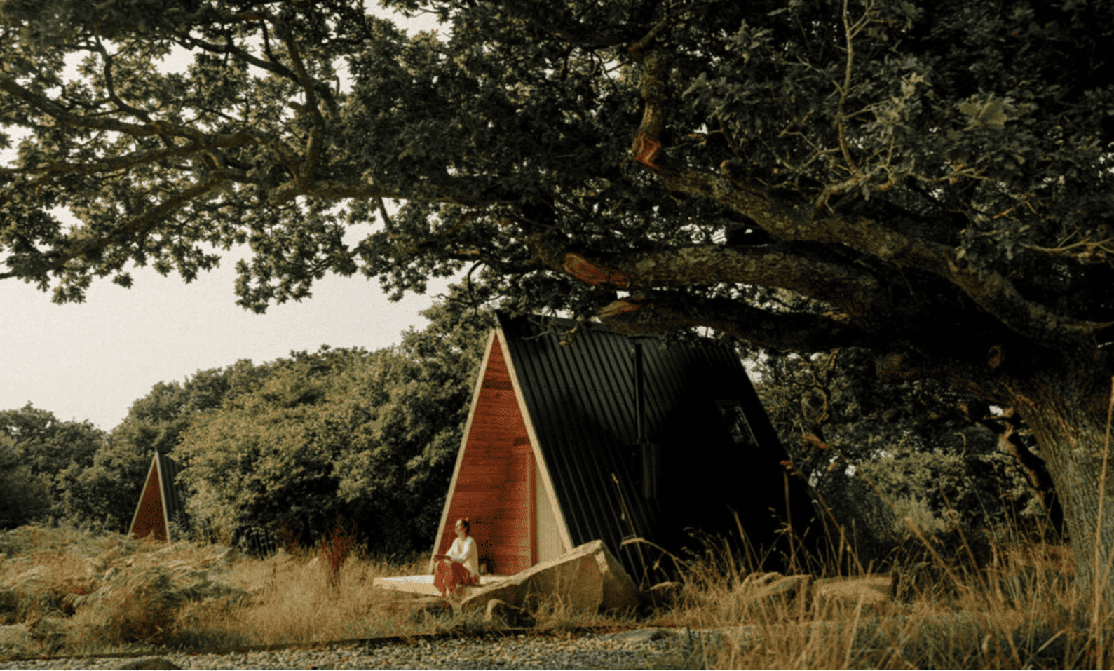 Guest relaxing outside an A-frame cabin at Cabilla Cornwall