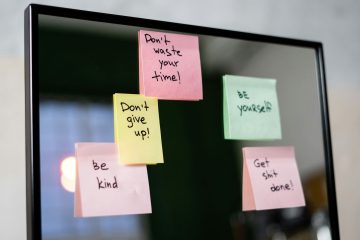 A mirror with five sticky notes, each with handwritten motivational messages like Don't waste your time! and Be kind—great daily reminders for anyone looking for tips on how to increase motivation when depressed or boost self-motivation.