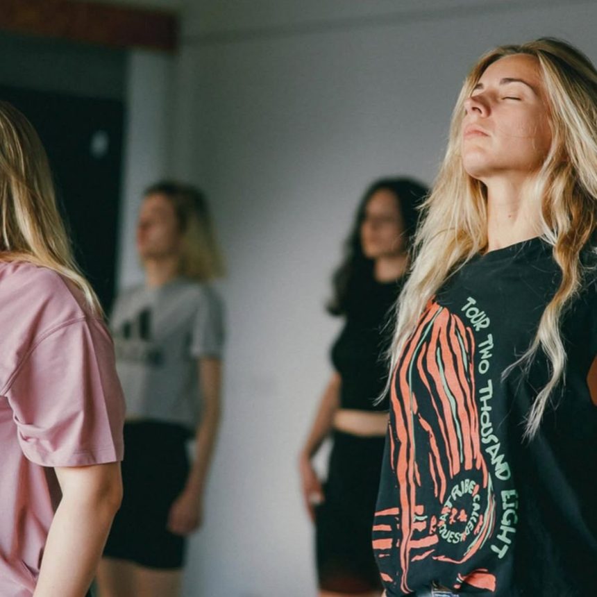 Woman with her eyes closed during a group breathwork practice