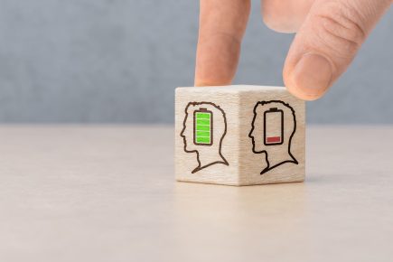 Wooden blocks with low battery symbols representing signs of burnout