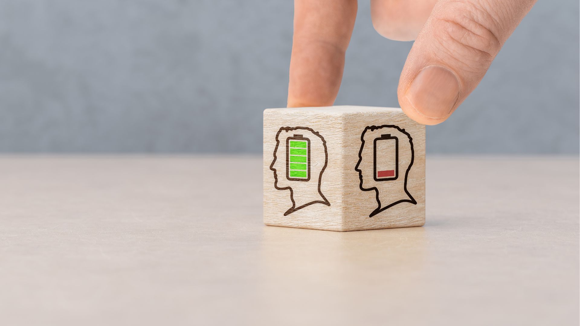 Wooden blocks with low battery symbols representing signs of burnout
