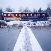 Snow-covered retreat centre beside a frozen lake in Sweden