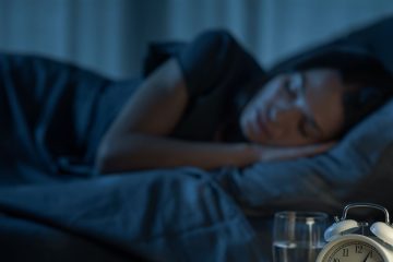 Person relaxing in bed before sleep