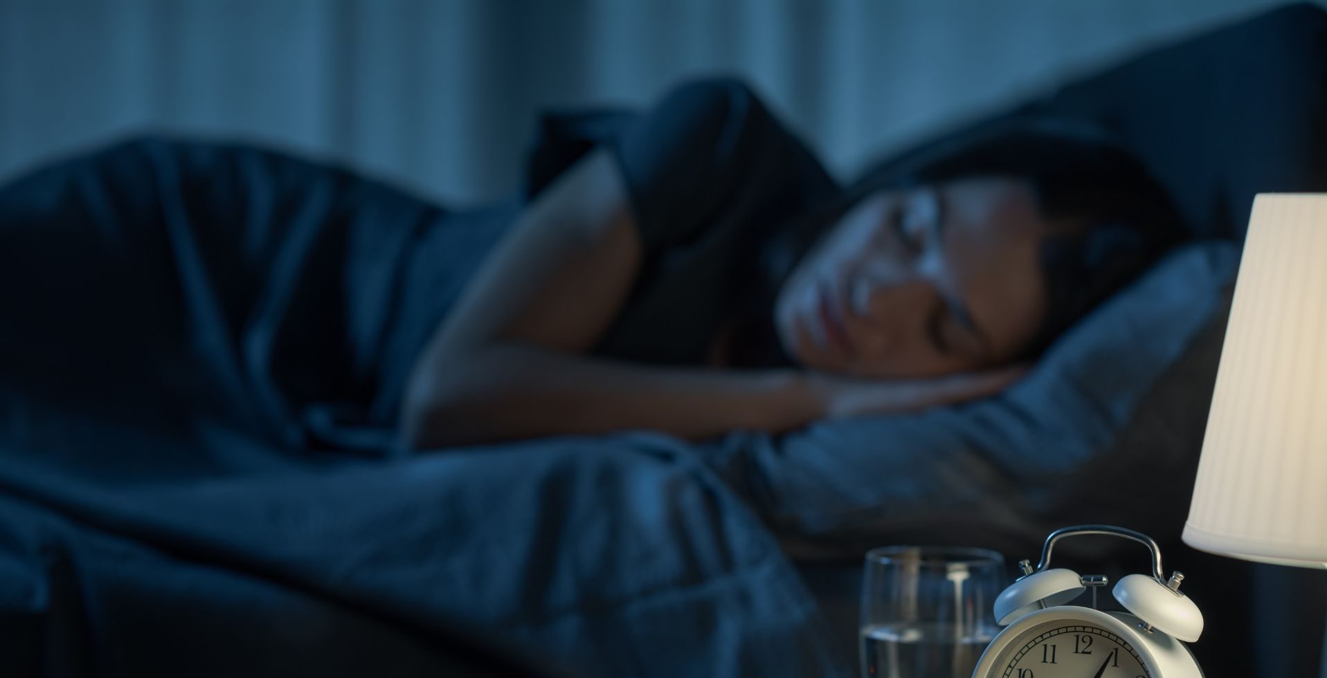 Person relaxing in bed before sleep