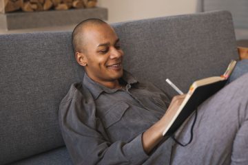 Man writing in a journal while practicing personal growth exercises