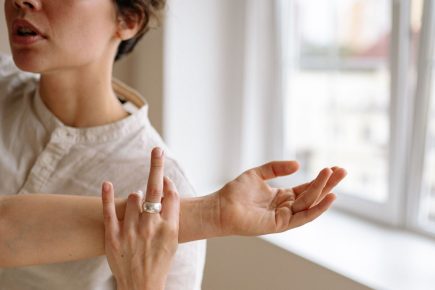 Woman practicing body awareness during a somatic coaching exercise